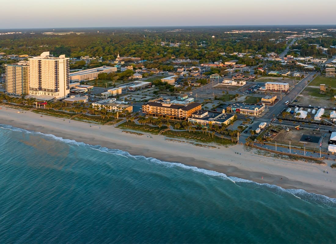 North Myrtle Beach, SC - Aerial View of Myrtle Beach, SC During Sunrise as the Waves Slowly Stat to Crash on the Beach